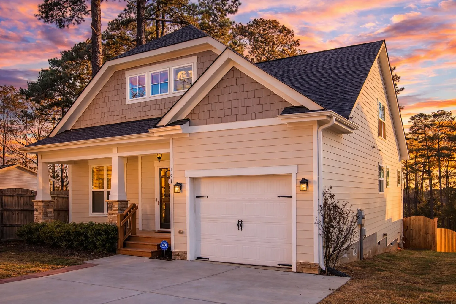 Front view of Modern Farmhouse Cottage home featuring board and batten siding, stone accents, and a welcoming front porch with gable roof design