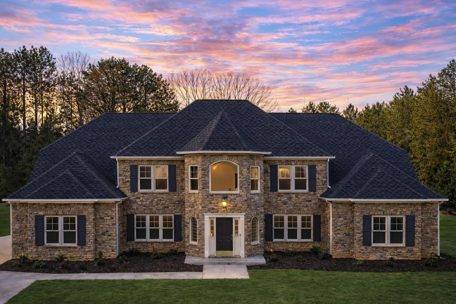 7 Bedroom House Plans 25 Front elevation of a Neo-Colonial luxury home featuring symmetrical design, brick exterior, stone entry surround, and classic shutters