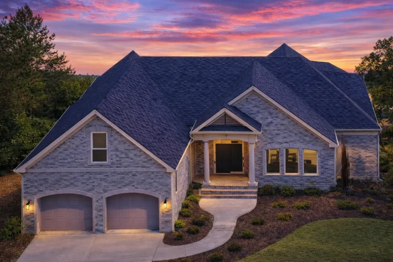 Front elevation of a New American modern traditional house with stone exterior, horizontal siding, gabled rooflines, and covered entry porch
