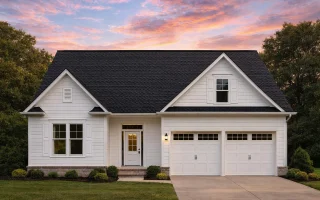 Front view of a Modern Farmhouse style home featuring horizontal siding, brick foundation, and dark wood carriage garage doors