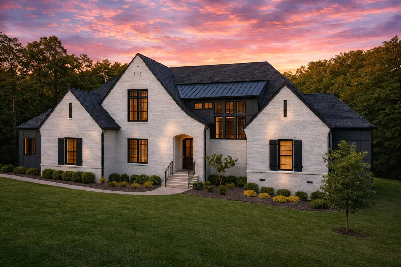 Front exterior of a New American modern traditional house with painted brick facade, steep gabled rooflines, dark windows, and manicured landscaping