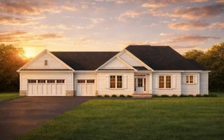 Front elevation of a Traditional Ranch style home with white horizontal lap siding, gable rooflines, and attached front-entry garage at sunset
