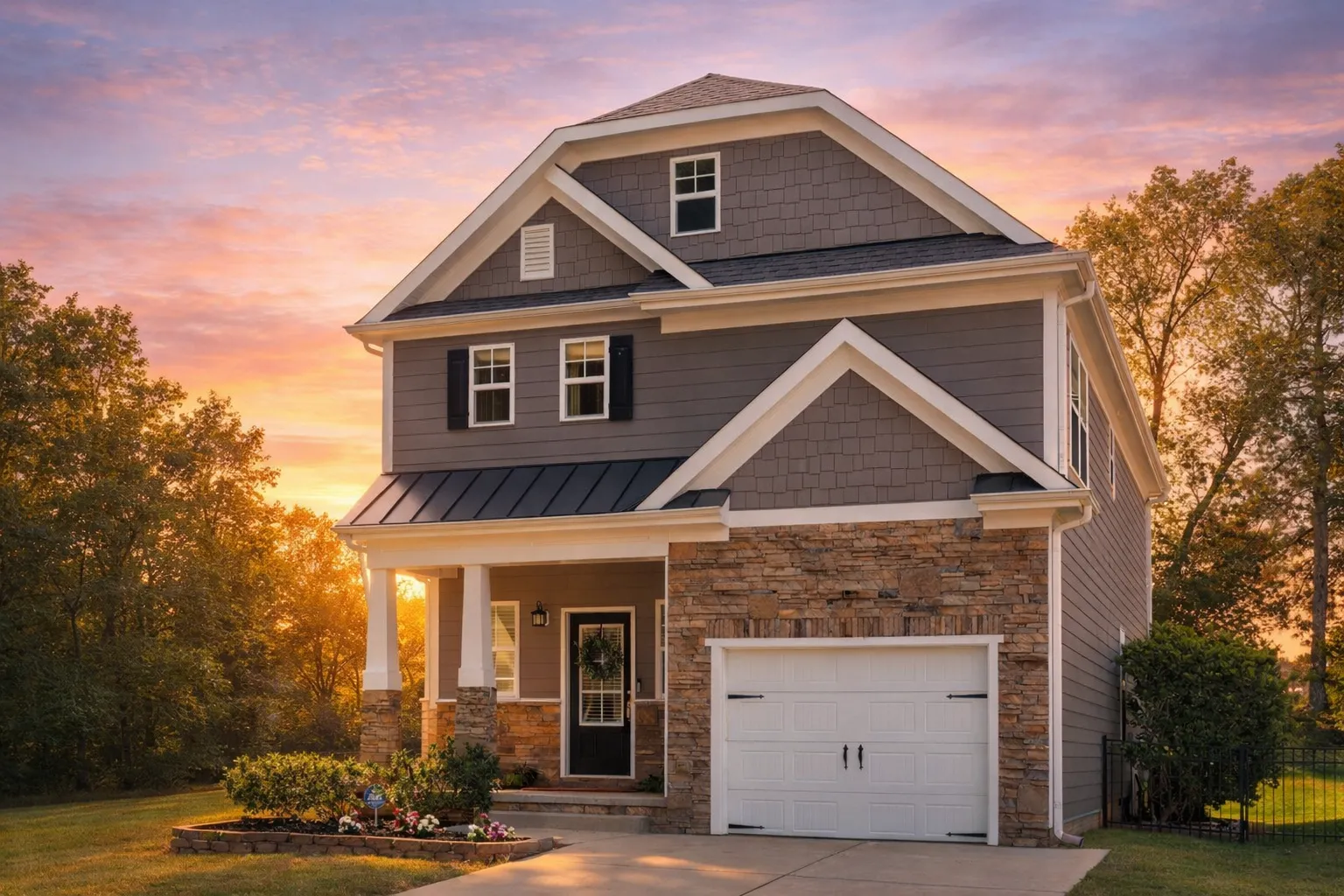Front view of a Modern Farmhouse style home featuring board and batten siding, stone accents, and wood trim with dark shutters and a front-entry garage.