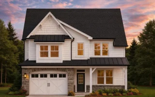 Front view of a Modern Farmhouse style home featuring white board and batten siding, stone detailing, and dark metal roof accents