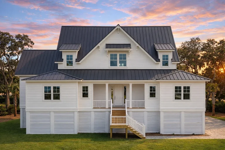 Front exterior view of an elevated Coastal Low Country style home with horizontal siding, metal roof, raised foundation, and covered porch