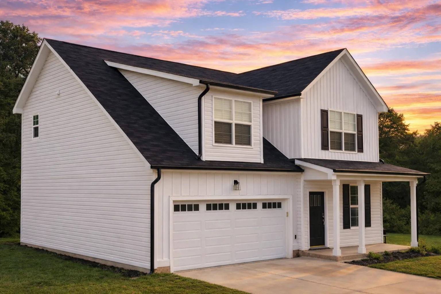 House Plans with Covered Deck 7 Front view of a Modern Farmhouse style home featuring a blend of horizontal lap and board and batten siding, dark trim accents, and a two-car garage.