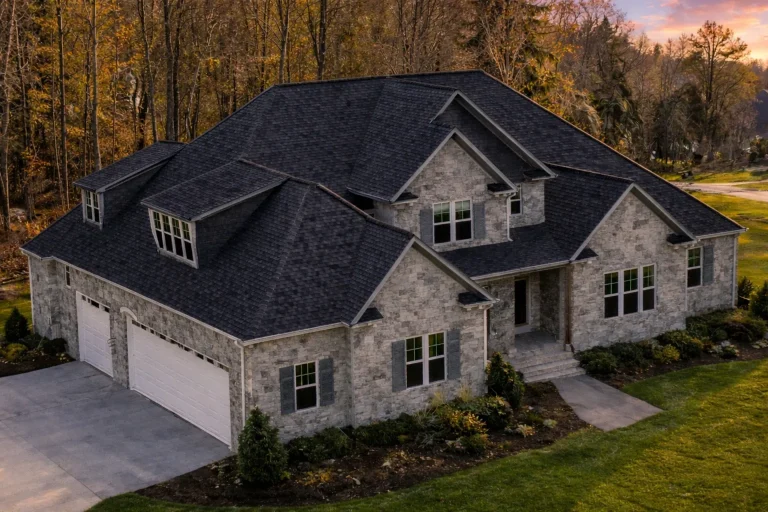 Front elevation of a New American / Modern Traditional house with horizontal lap siding, stone veneer accents, and a welcoming covered porch