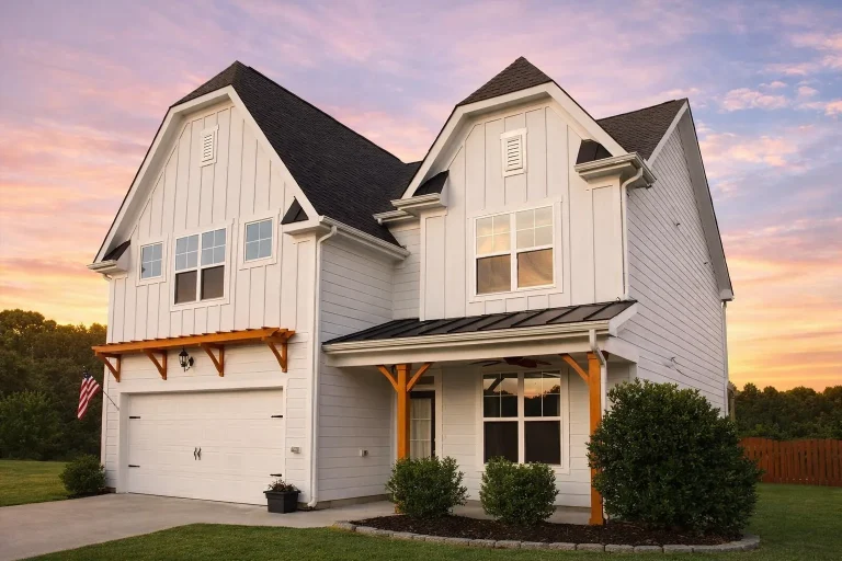 Front elevation of a New American modern farmhouse home featuring board and batten siding, covered porch, and Craftsman details