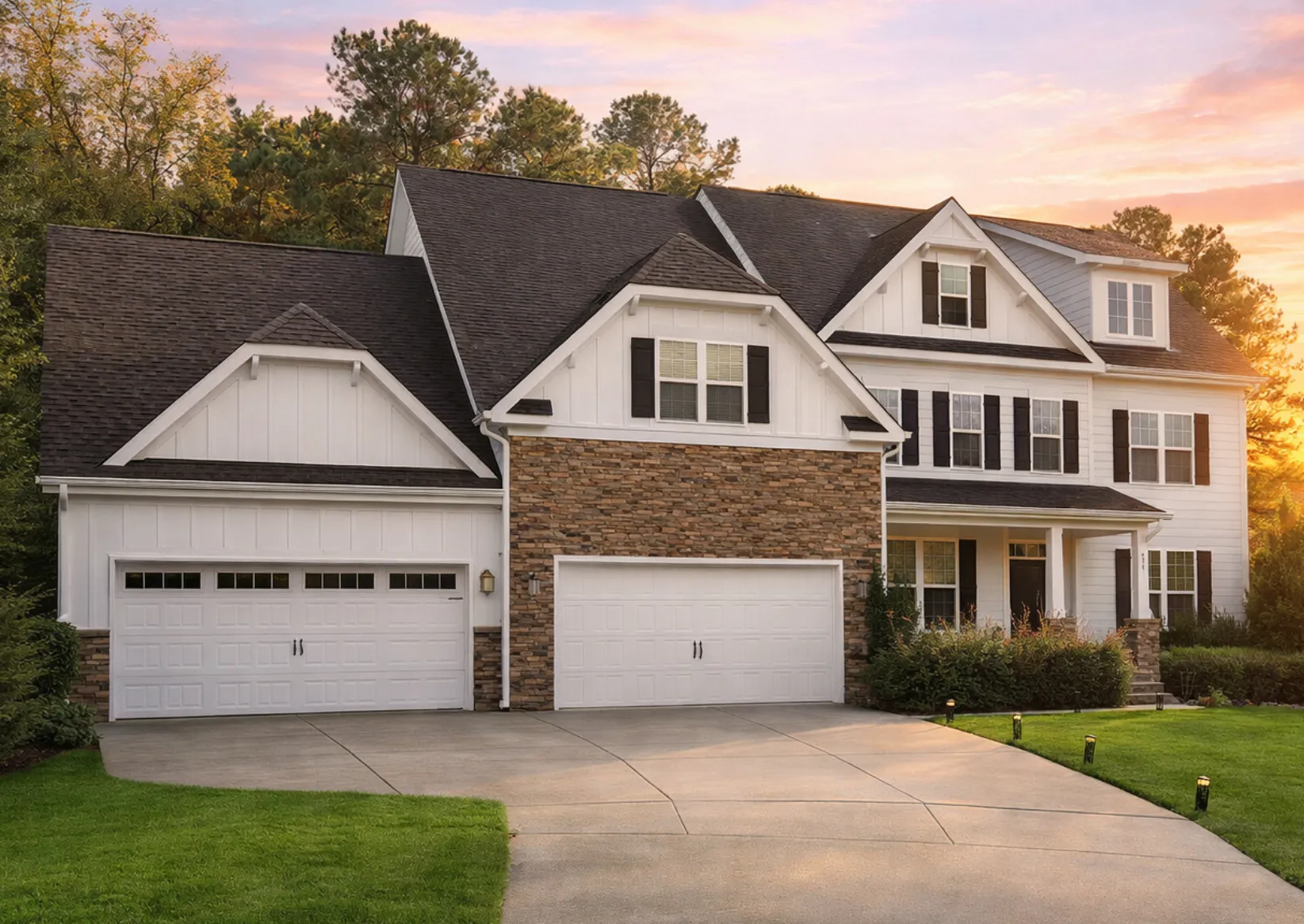 Front elevation of a New American modern traditional house with horizontal siding, stone accents, gabled rooflines, and covered porch