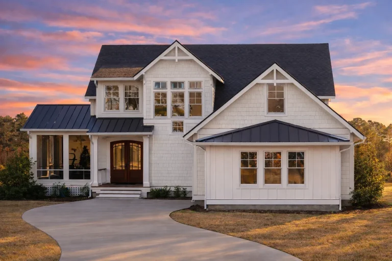 Front elevation of a Modern Farmhouse with horizontal siding, board-and-batten detailing, large covered porch, and symmetrical window arrangement