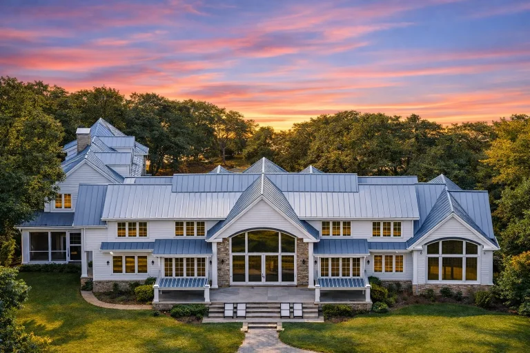 Front elevation of a Colonial Neo-Colonial style home featuring a full-width covered porch, symmetrical facade, lap siding, and brick foundation