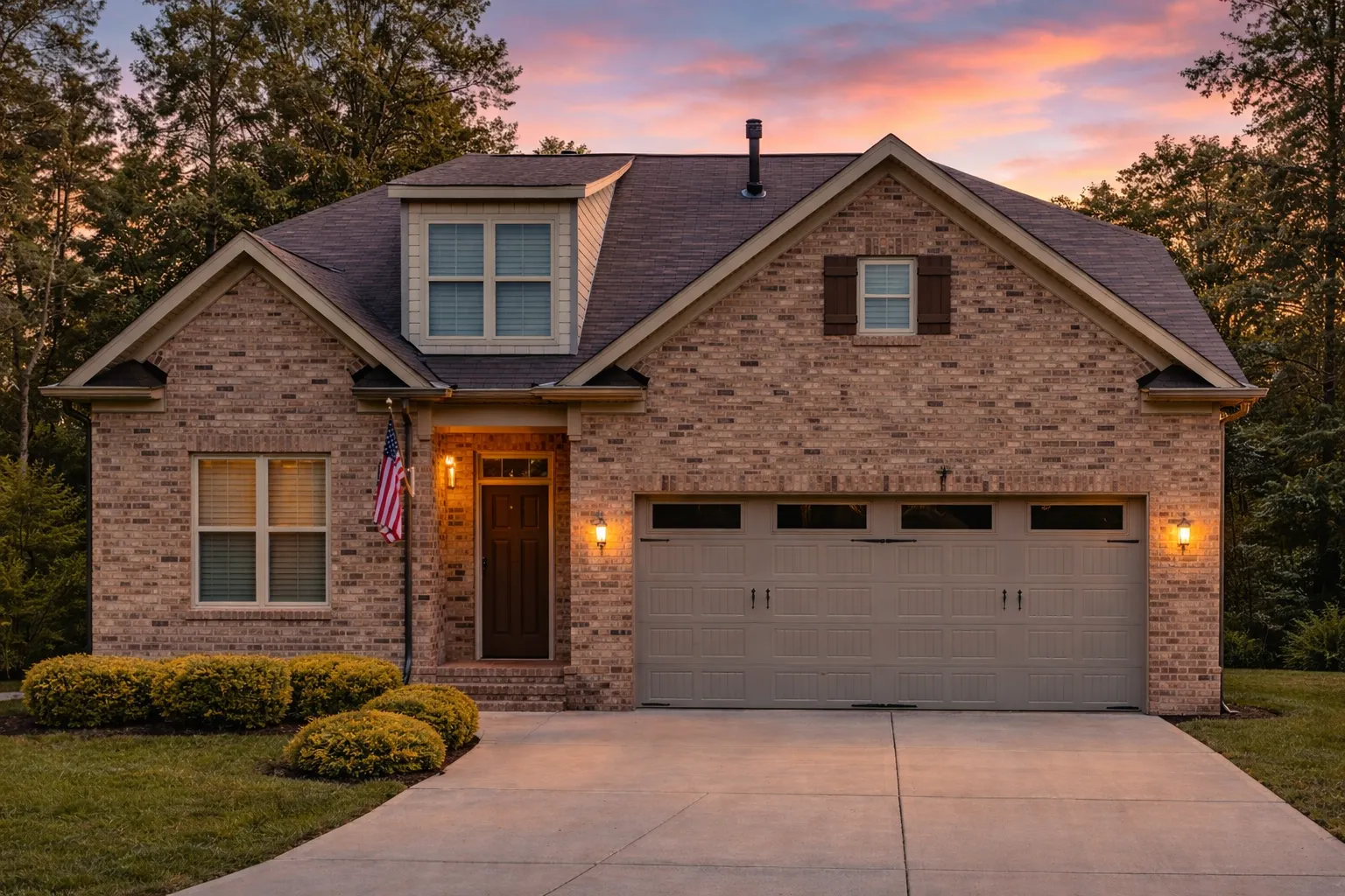 Front elevation of a Traditional Tudor Revival style home with brick exterior, steep gable rooflines, and symmetrical façade.