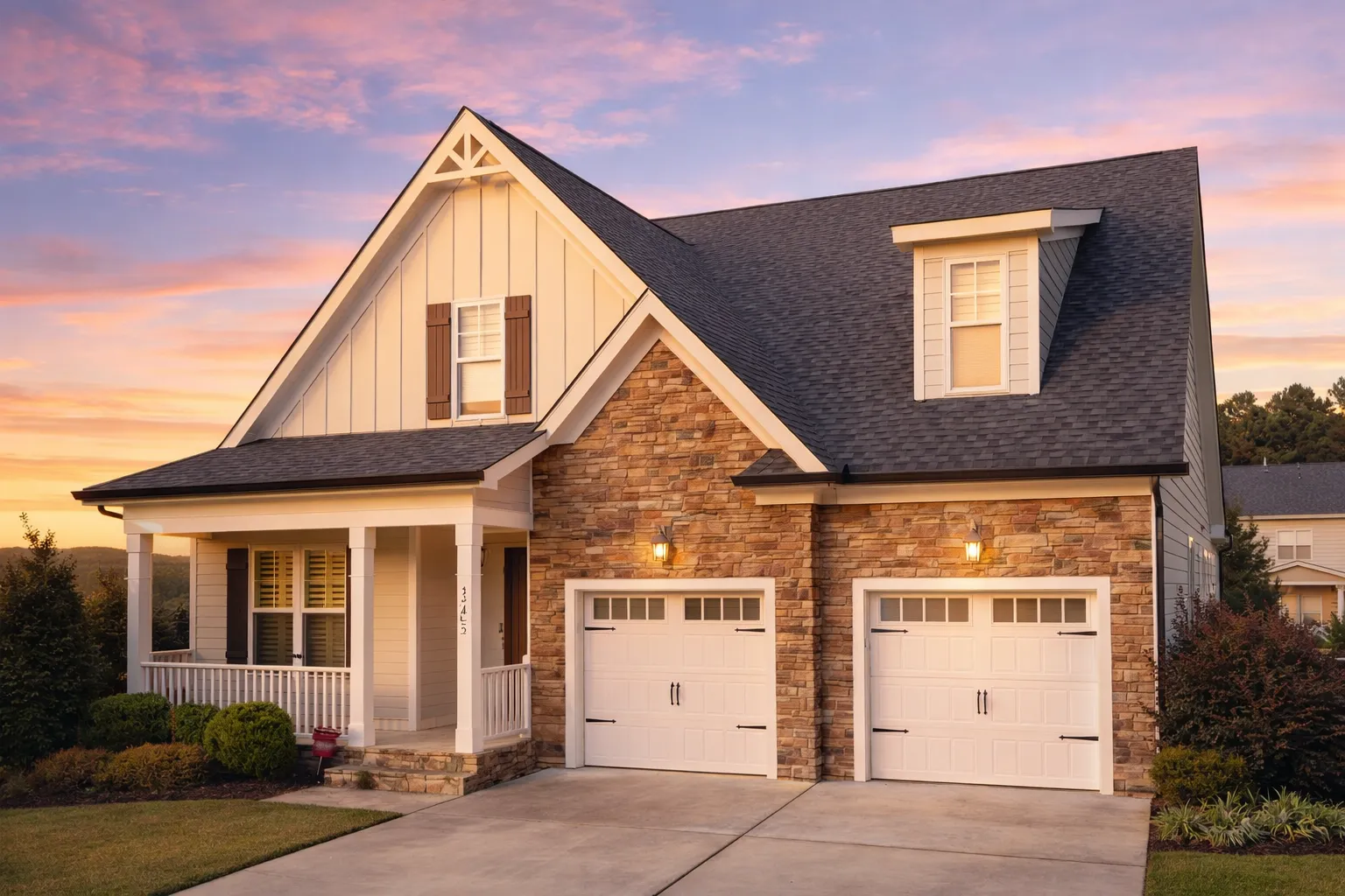 Front elevation of a Modern Farmhouse style home featuring board and batten siding, horizontal lap siding, stone accents, and a two-car garage with dark wood doors