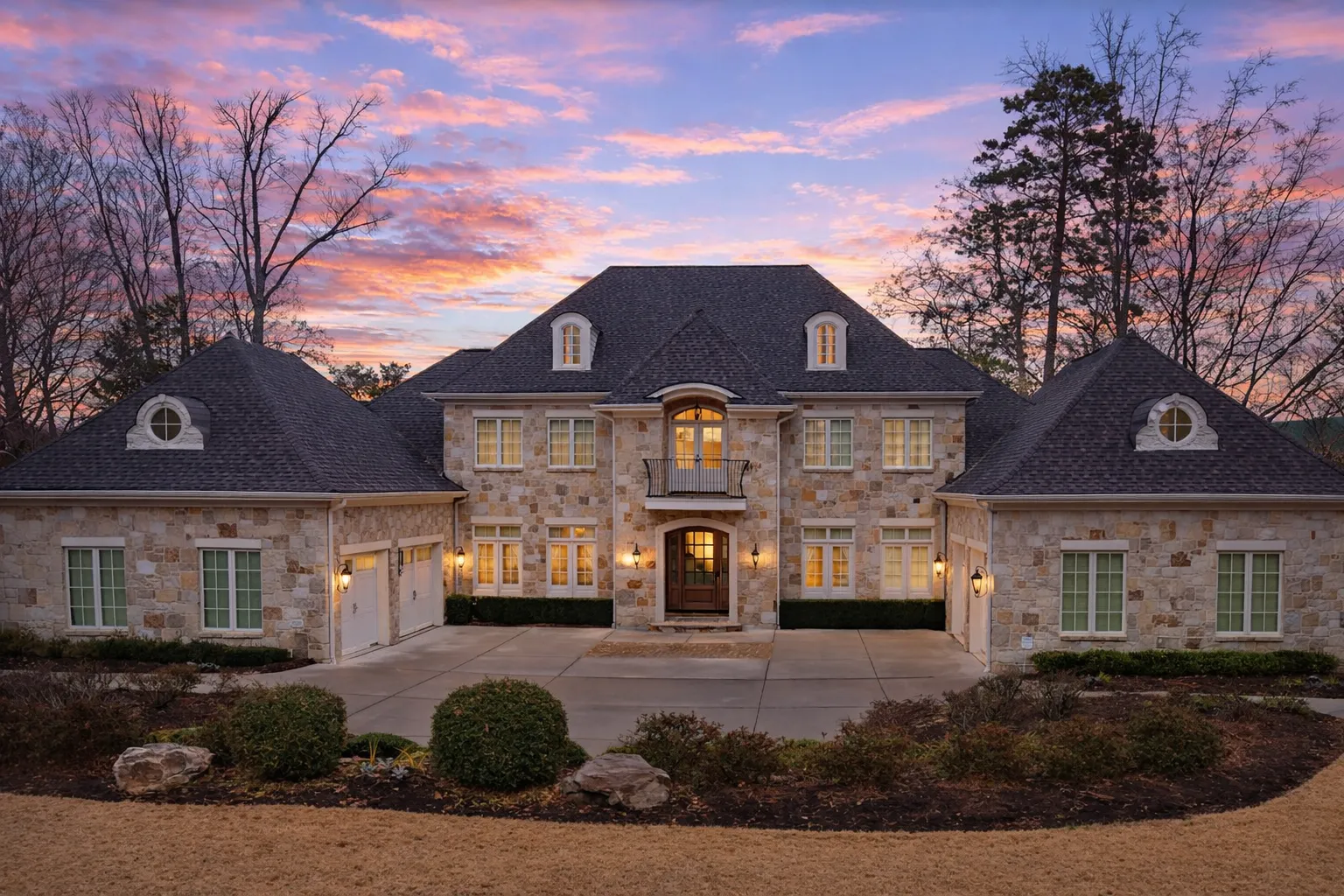 Bungalow House Plans 19 Front elevation of a French Country European Traditional estate home featuring brick exterior, stone accents, steep hipped roof, dormers, and symmetrical façade