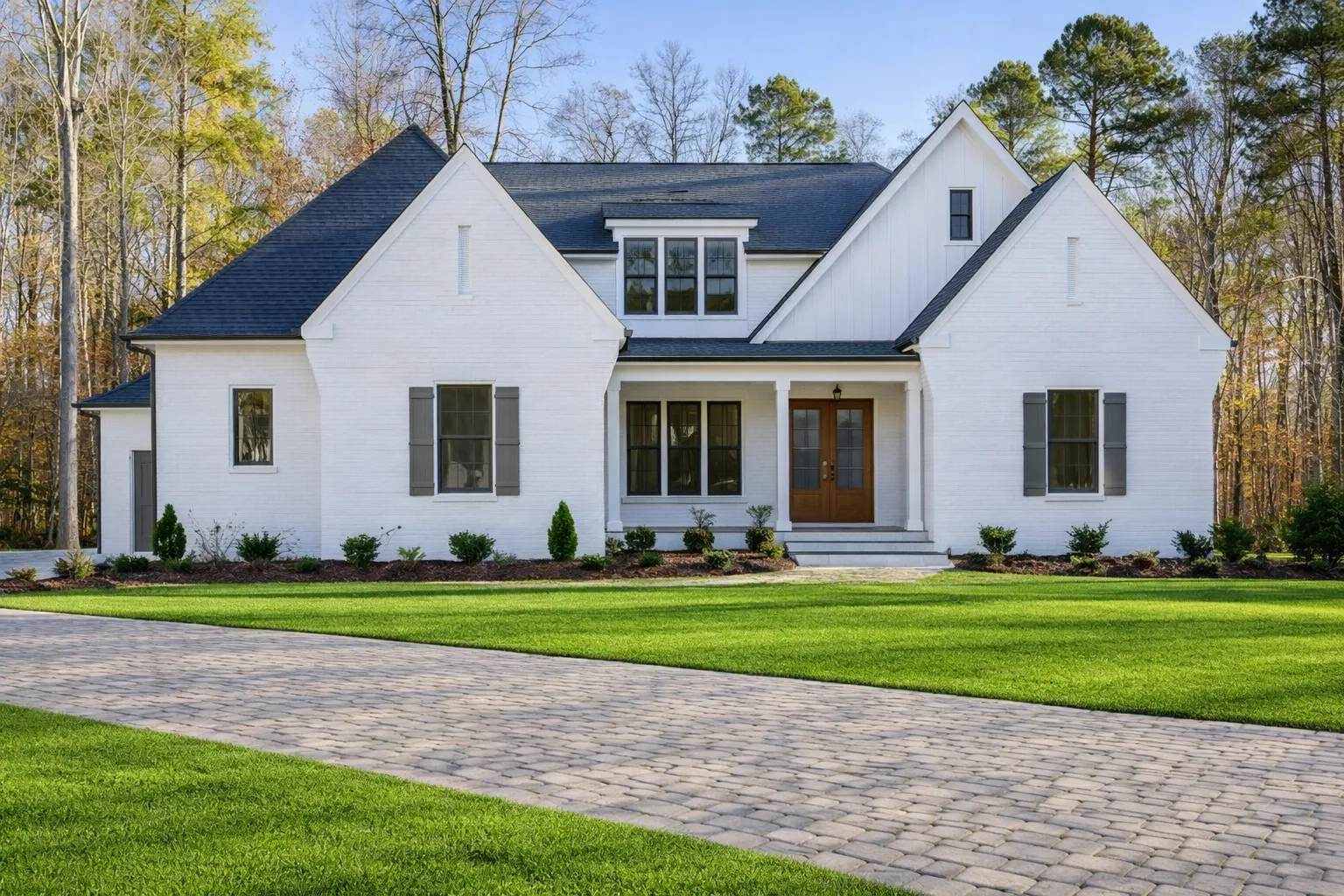 RV Garage Plans 3 Front elevation of a Modern Farmhouse style home with white painted brick, board and batten siding, steep gables, and covered porch
