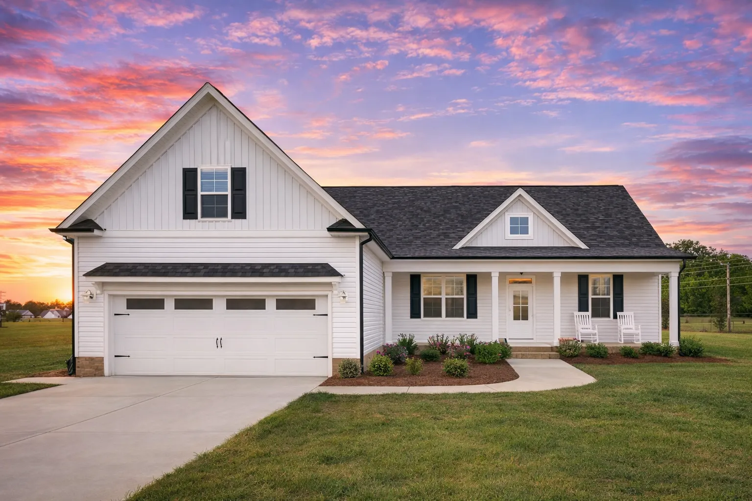 Front view of a Modern Farmhouse Ranch home featuring board and batten siding, horizontal lap accents, brick foundation, and dark trim with a gable roof design