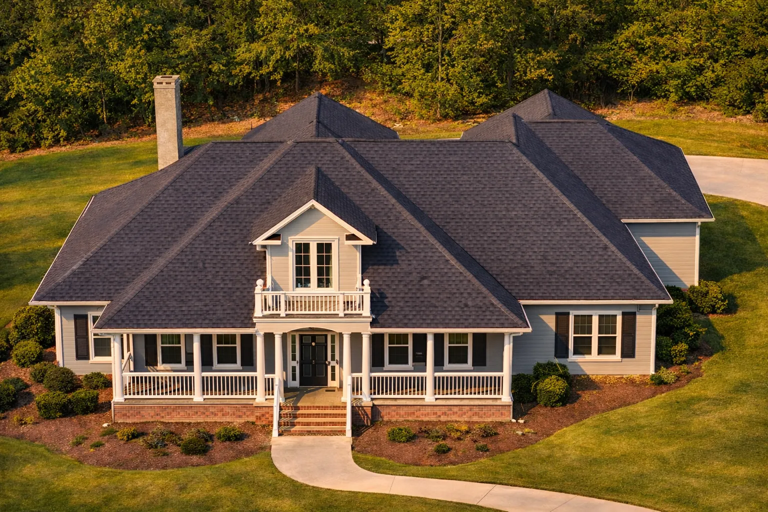 Front elevation of a Classical Southern style home with white lap siding, symmetrical windows, a covered front porch, and a dark shingle roof