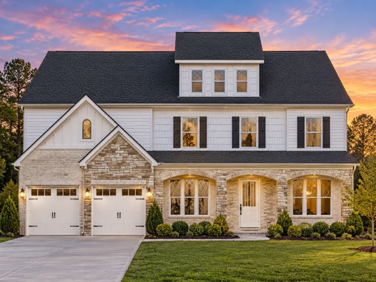 Front elevation of a New American Modern Traditional house with Colonial symmetry, mixed siding exterior, covered front porch, and attached two-car garage