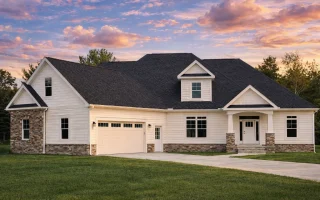 Front view of a Traditional Ranch Craftsman style home featuring a combination of stone accents, horizontal siding, and board and batten details with a welcoming covered entry.