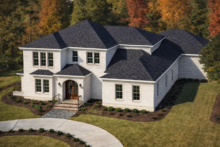 Front exterior of a New American modern traditional house with symmetrical colonial design, painted lap siding, gabled rooflines, and elegant entry porch