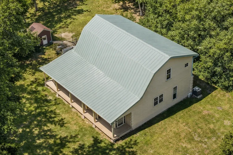 Front elevation of a rustic cabin style home featuring natural log siding, symmetrical windows, and a simple gable roof design