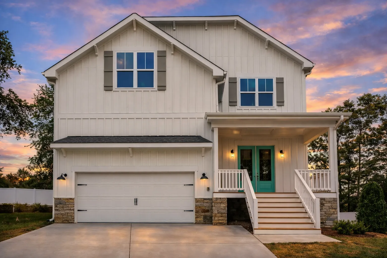 Front elevation of a modern farmhouse style home featuring board and batten siding, stone foundation accents, covered porch, and attached two-car garage