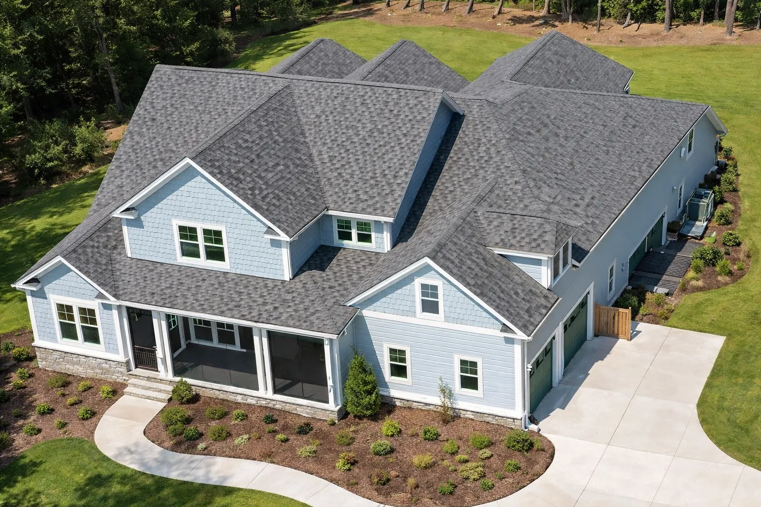 Front elevation of a New American coastal traditional house featuring shingle siding, horizontal lap siding, stone accents, and a welcoming covered porch