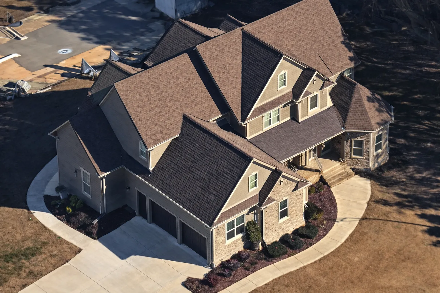 Front elevation of a Traditional Colonial style brick home with symmetrical windows, gabled rooflines, and classic Georgian-inspired detailing