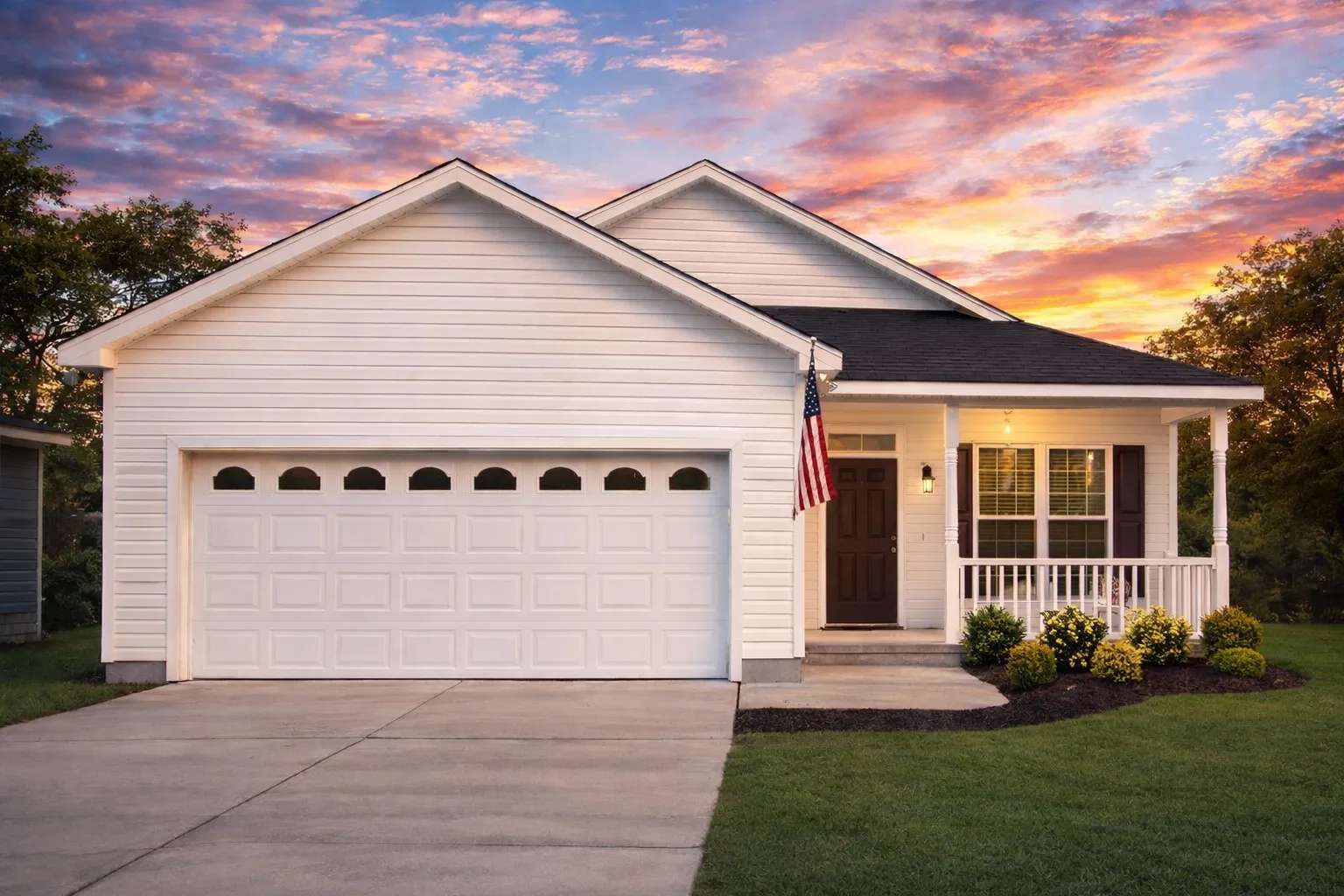 Traditional Ranch style home with horizontal siding, shake gable detailing, stone column bases, and a covered entry