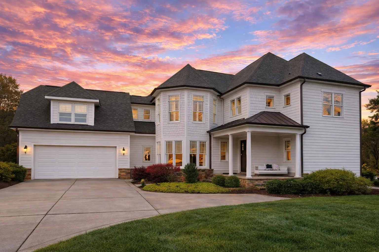Front elevation of New American Modern Traditional two-story home with white horizontal siding, covered entry, and attached two-car garage
