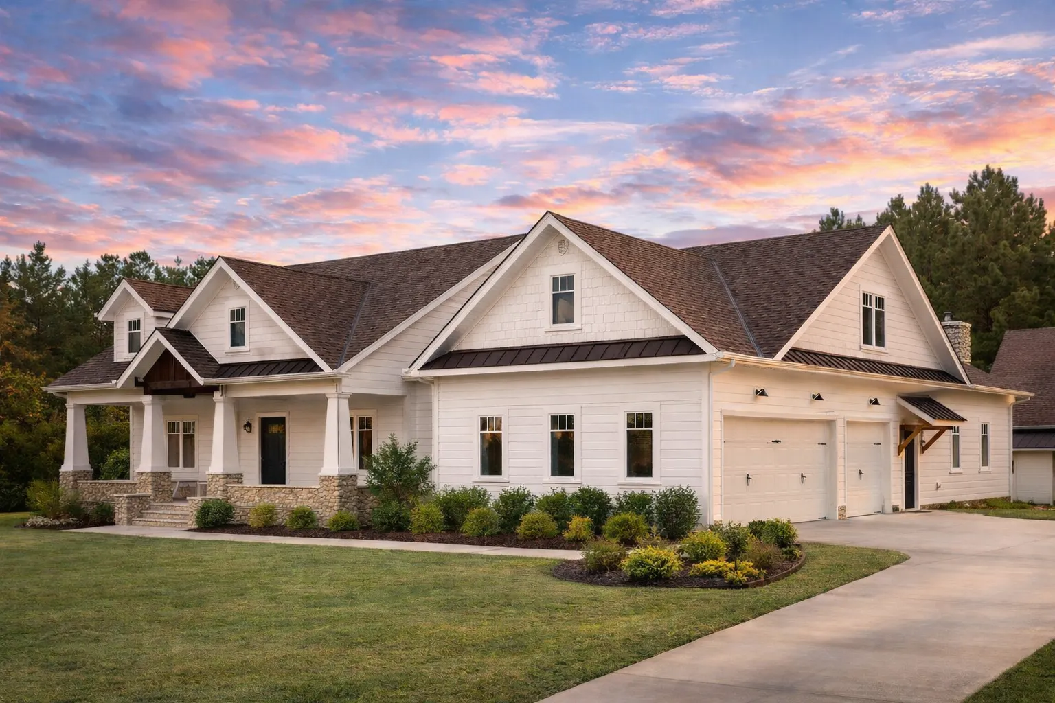 Front elevation of a New American Ranch style house with horizontal siding, board and batten gables, stone base, and covered porch