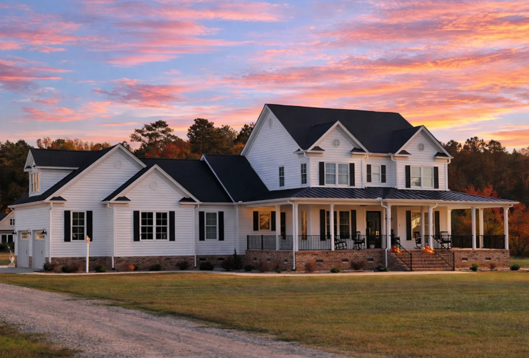 Front elevation of a New American Modern Traditional style house featuring horizontal lap siding, stone accents, black shutters, and a covered front porch
