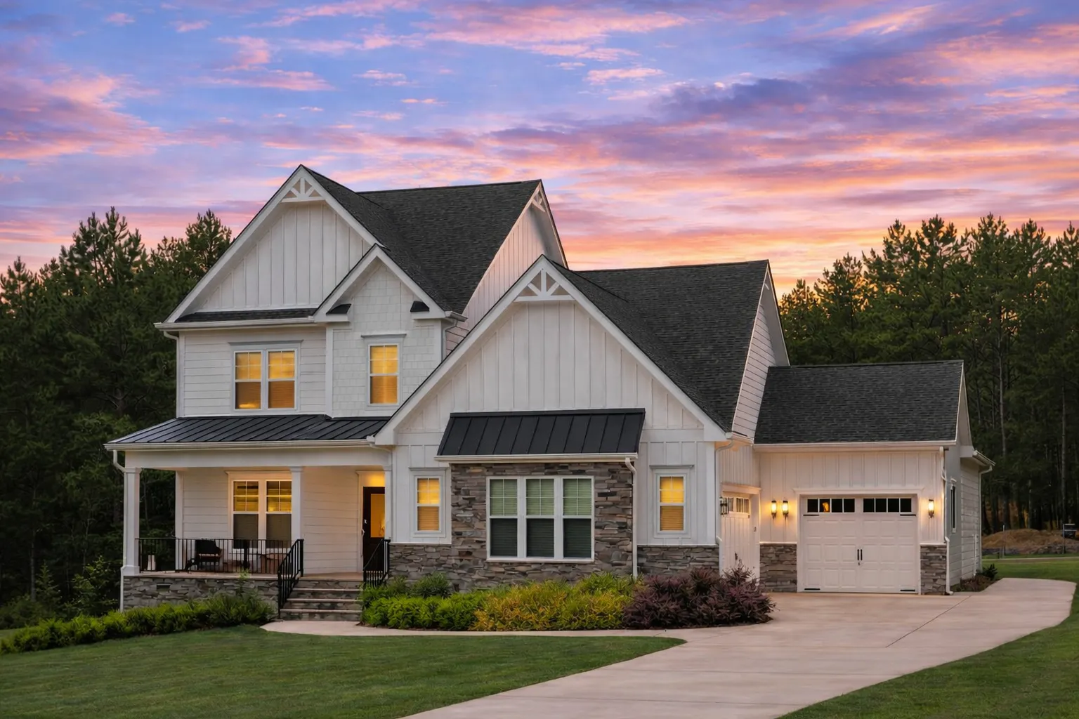 Front exterior of a New American Modern Traditional house with board and batten siding, stone veneer, gabled rooflines, and welcoming covered porch