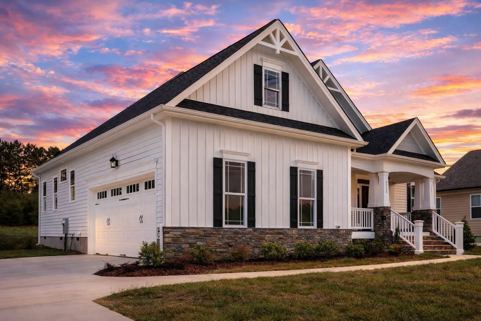 House Plans with Covered Driveway 19 Front exterior view of a Modern Farmhouse Craftsman style home with white board and batten siding, stone foundation accents, black shutters, and a covered front porch