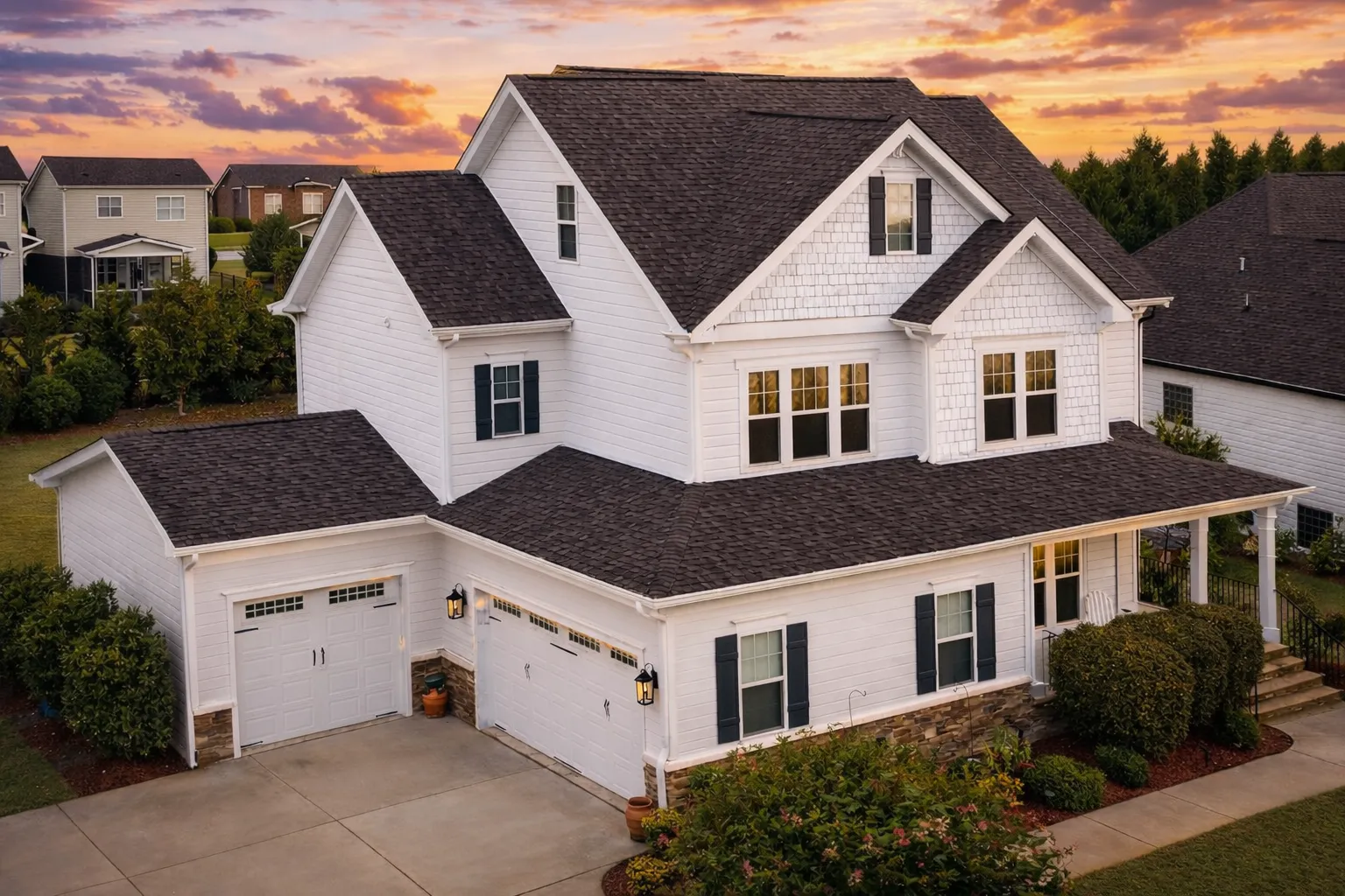 Front elevation of a Coastal Farmhouse style house featuring board and batten siding, shingle accents, covered porch, and symmetrical New American design