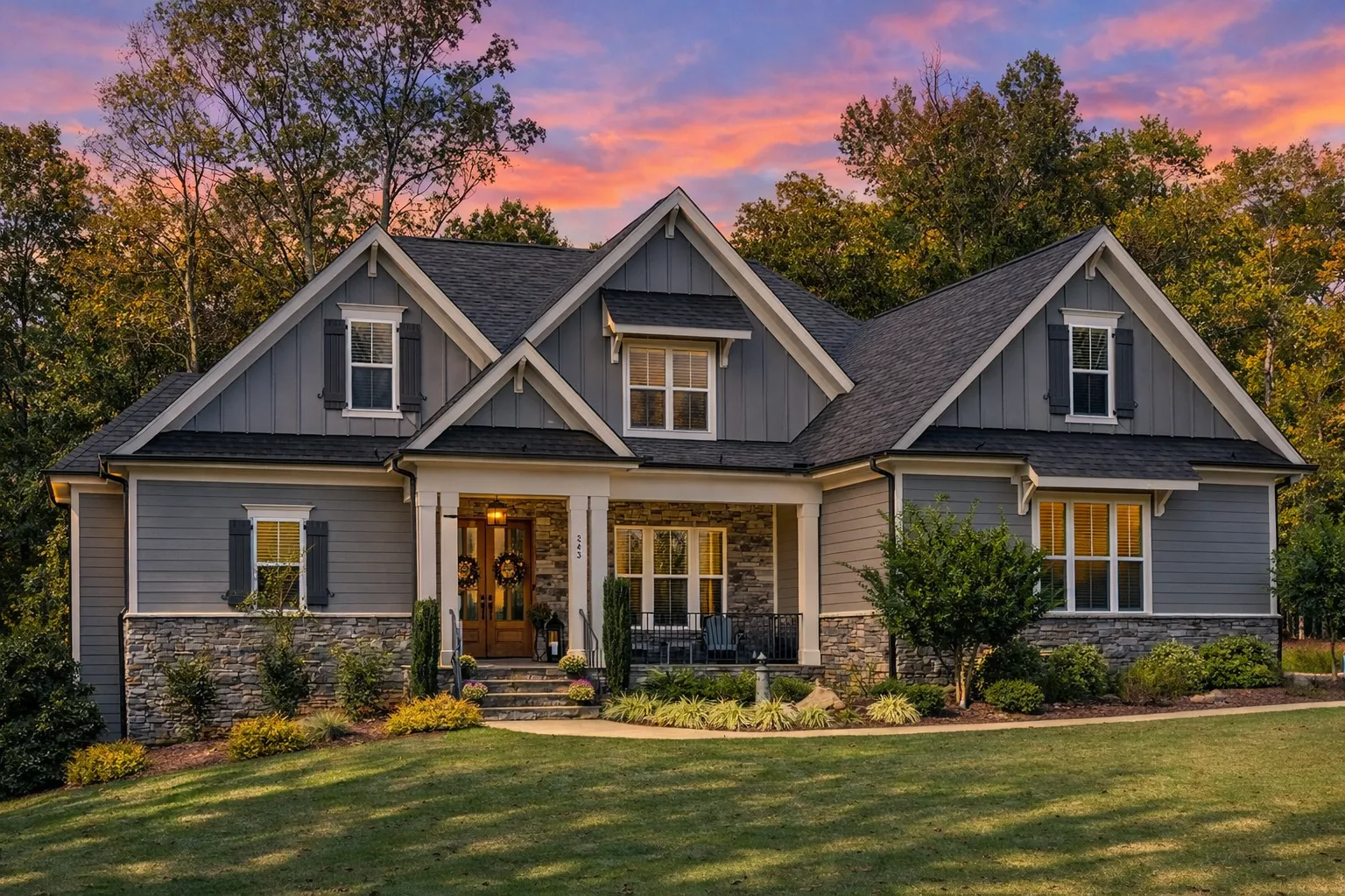 Front exterior view of a New American Modern Traditional style home featuring horizontal siding, stone accents, gabled rooflines, and covered front porch