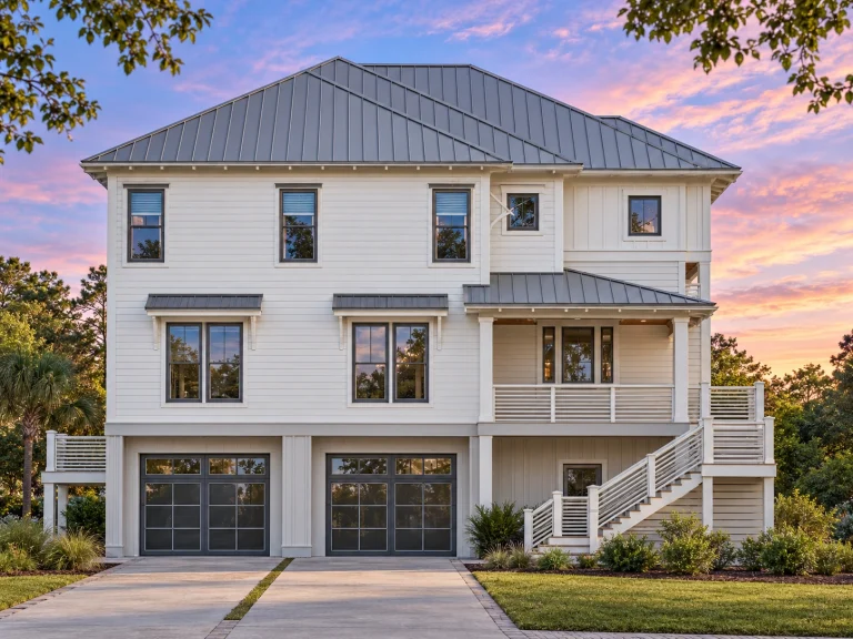 Front elevation of a Coastal Traditional style home with elevated garage, horizontal siding, covered porch, and classic Colonial proportions