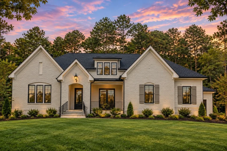 Ranch House Plans 9 Front elevation of a Modern Farmhouse style home with smooth white stucco exterior, black-framed windows, gabled rooflines, and covered entry porch