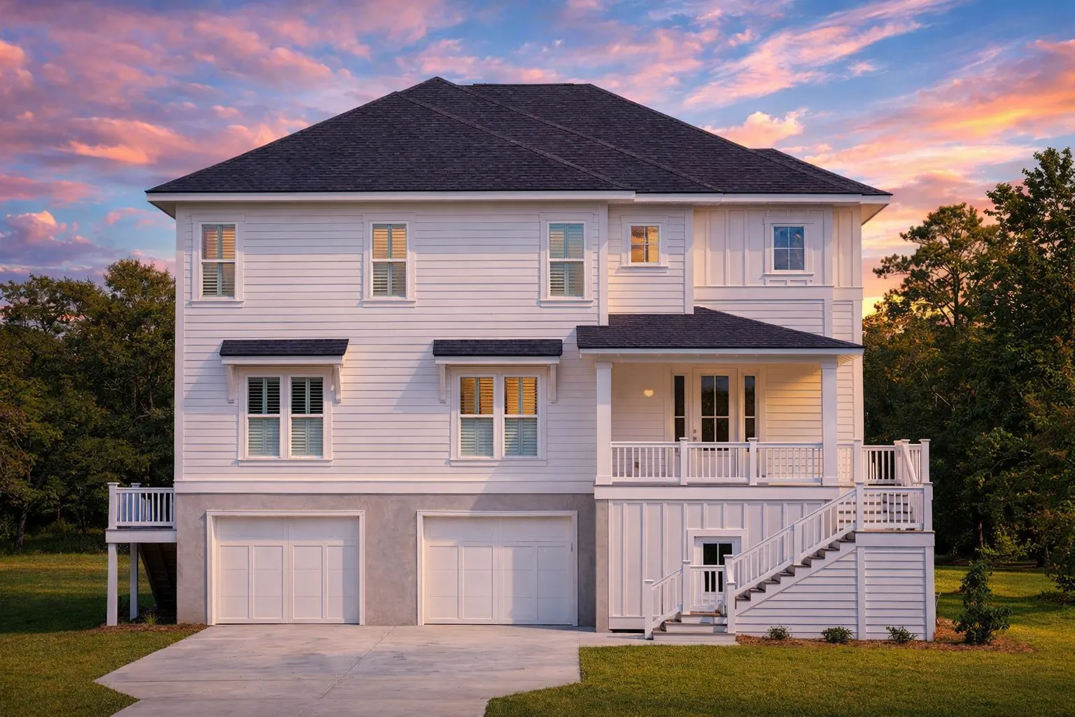 Front elevation of a Coastal Traditional style home with elevated garage, horizontal siding, covered porch, and classic Colonial proportions