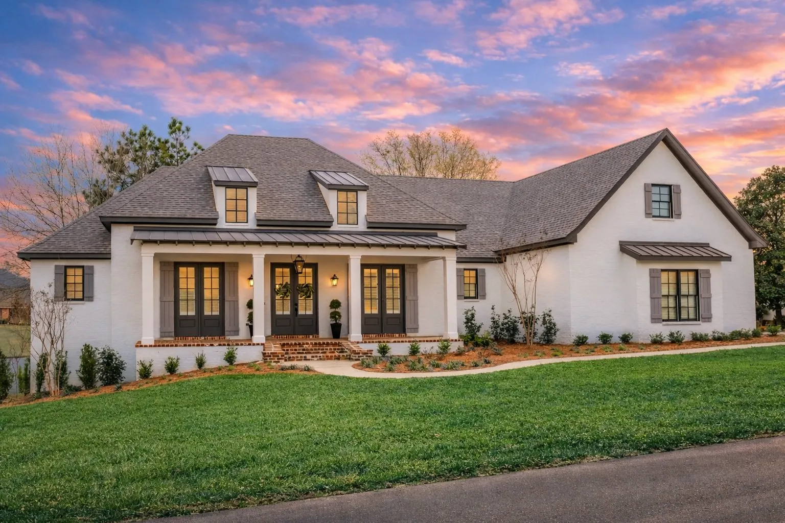 House Plans 23 Front elevation of a New American style house featuring painted brick, board and batten siding, gabled rooflines, and a welcoming covered porch