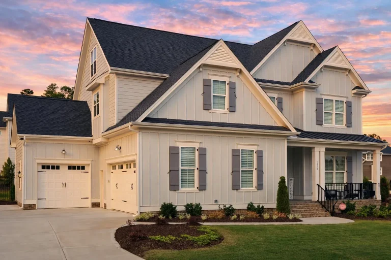 Front elevation of a Modern Farmhouse and New American style home featuring board and batten siding, gabled rooflines, and a welcoming covered front porch