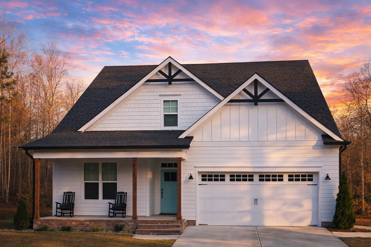 Front elevation of a New American Craftsman style house featuring horizontal siding, board and batten gables, stone accents, and a two-car garage