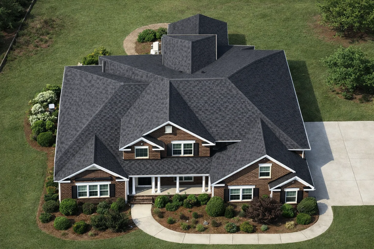 Front elevation of a Traditional Colonial Revival style home with brick exterior, gabled rooflines, and welcoming covered entry