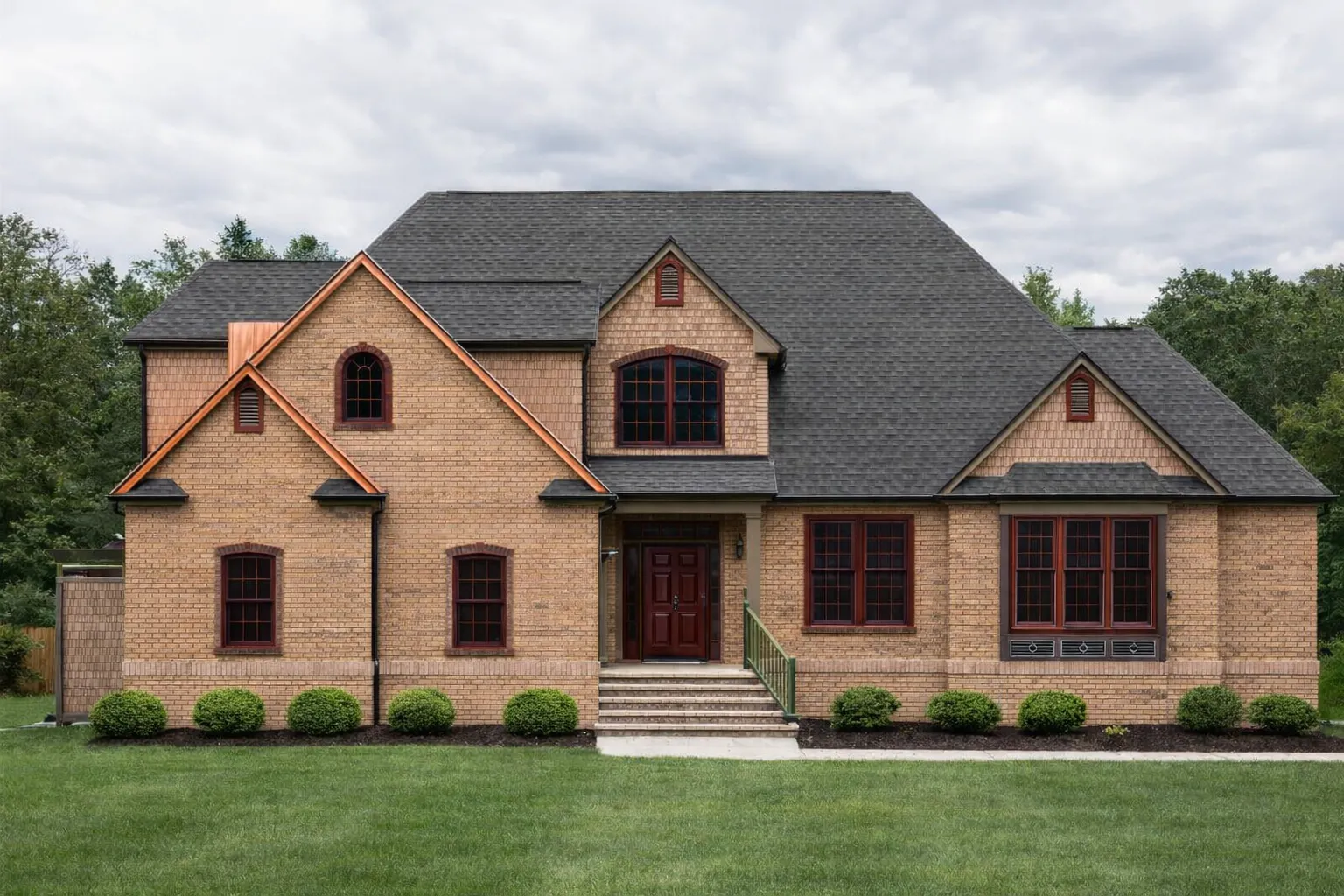 Front exterior view of a Traditional Colonial style home with full brick exterior, symmetrical window layout, steep gabled roof, and classic entry porch