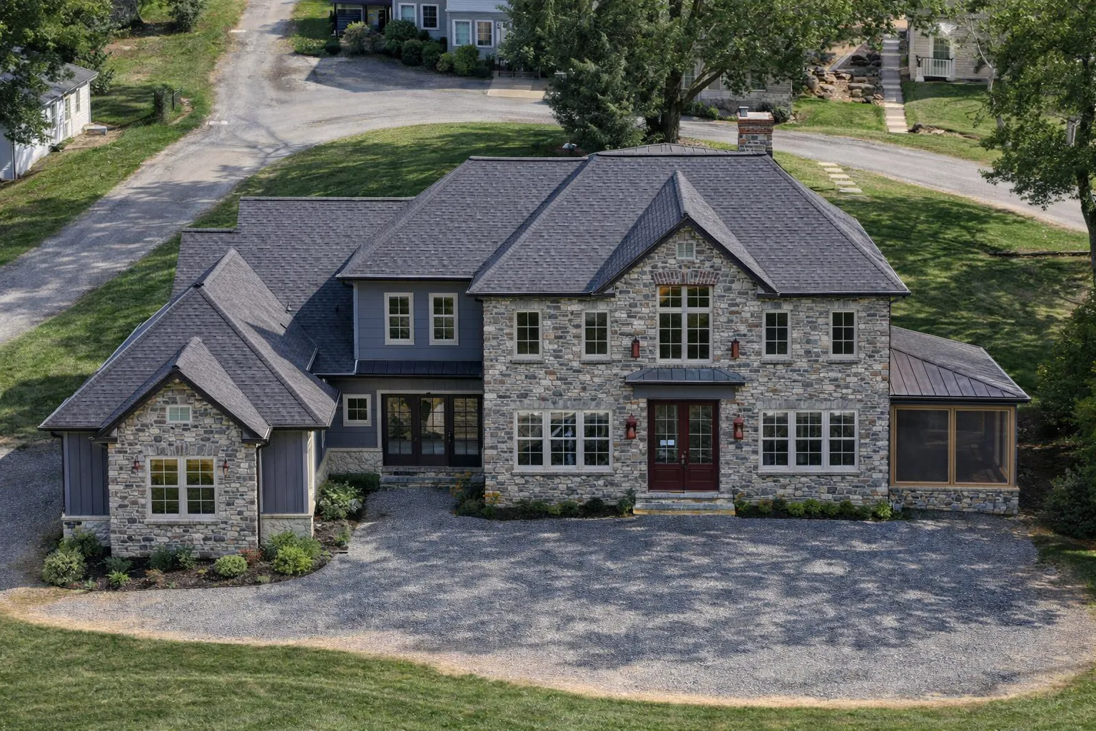 House Plans 7 Front elevation of a Traditional Colonial Revival home with brick exterior, symmetrical windows, black shutters, and covered side porch