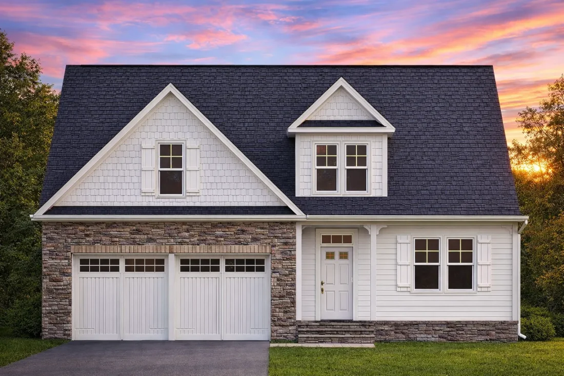 Front elevation of Cape Cod cottage style home with shingle siding, stone veneer wainscot, gable roof, and two-car garage