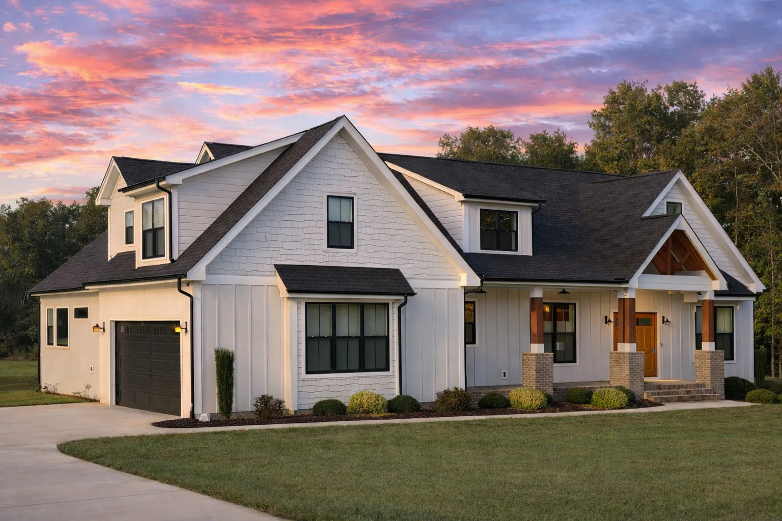 Front elevation of a Craftsman style home featuring board and batten siding, brick foundation, gabled rooflines, and a welcoming covered porch