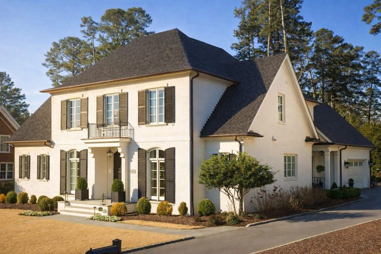 Garage Workshop Plans 1 Front elevation of a Georgian Colonial style home with painted brick exterior, symmetrical windows, shutters, and classic entry porch