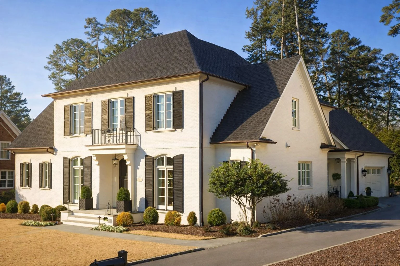House Plans 11 Front elevation of a Georgian Colonial style home with painted brick exterior, symmetrical windows, shutters, and classic entry porch