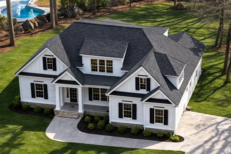 4 Bedroom House Plans 15 Front elevation of a New American Traditional house with Cape Cod styling, lap siding, shingle accents, symmetrical windows, and a welcoming covered entry